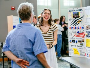 Carol Cortonezi laughs with Dr. Laura Zangori at the MIE poster showcase