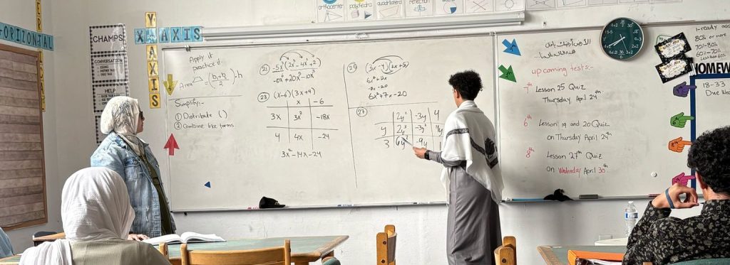 Student working at a whiteboard.