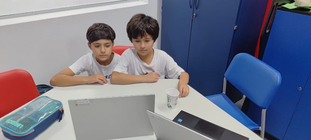 Students watching a laptop.