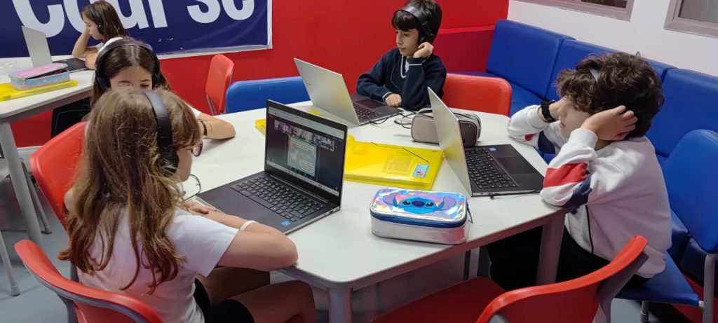 Students listening to laptops.